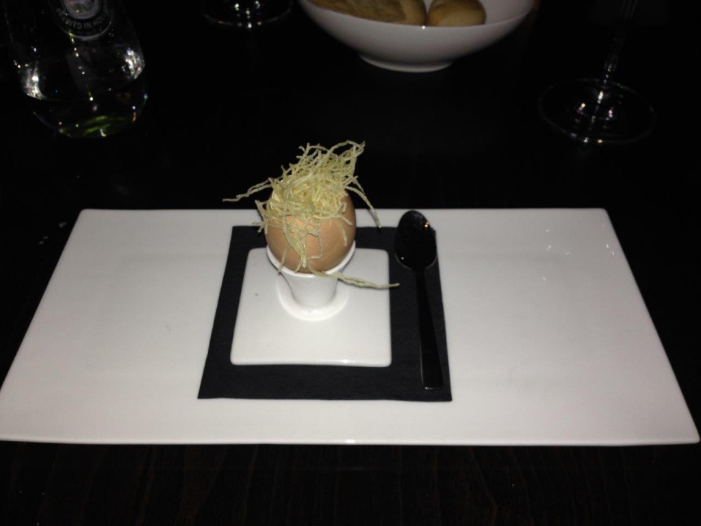  a delicious carbonara sauce served in the shell of an egg.