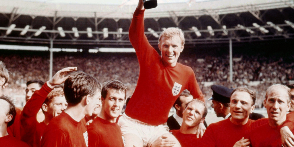 England's soccer captain Bobby Moore, carried shoulder high by his team mates holds aloft the FIFA World Cup in this July 30 1966 file photo. England defeated Germany 4-2 in the final of the 1966 tournament played at London's Wembley Stadium. (AP Photo)